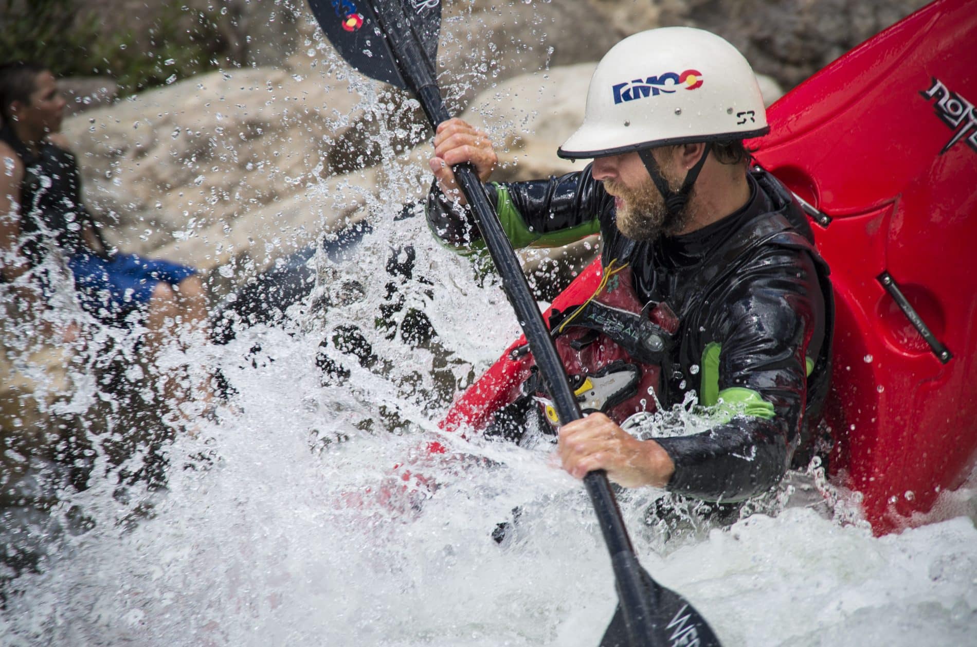 Kayaker splashing through the water
