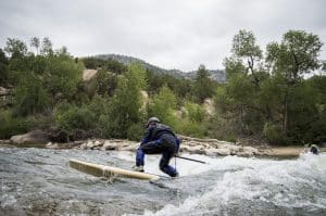 Paddleboarding on a wave