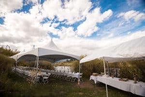 Large white tent with tables underneath