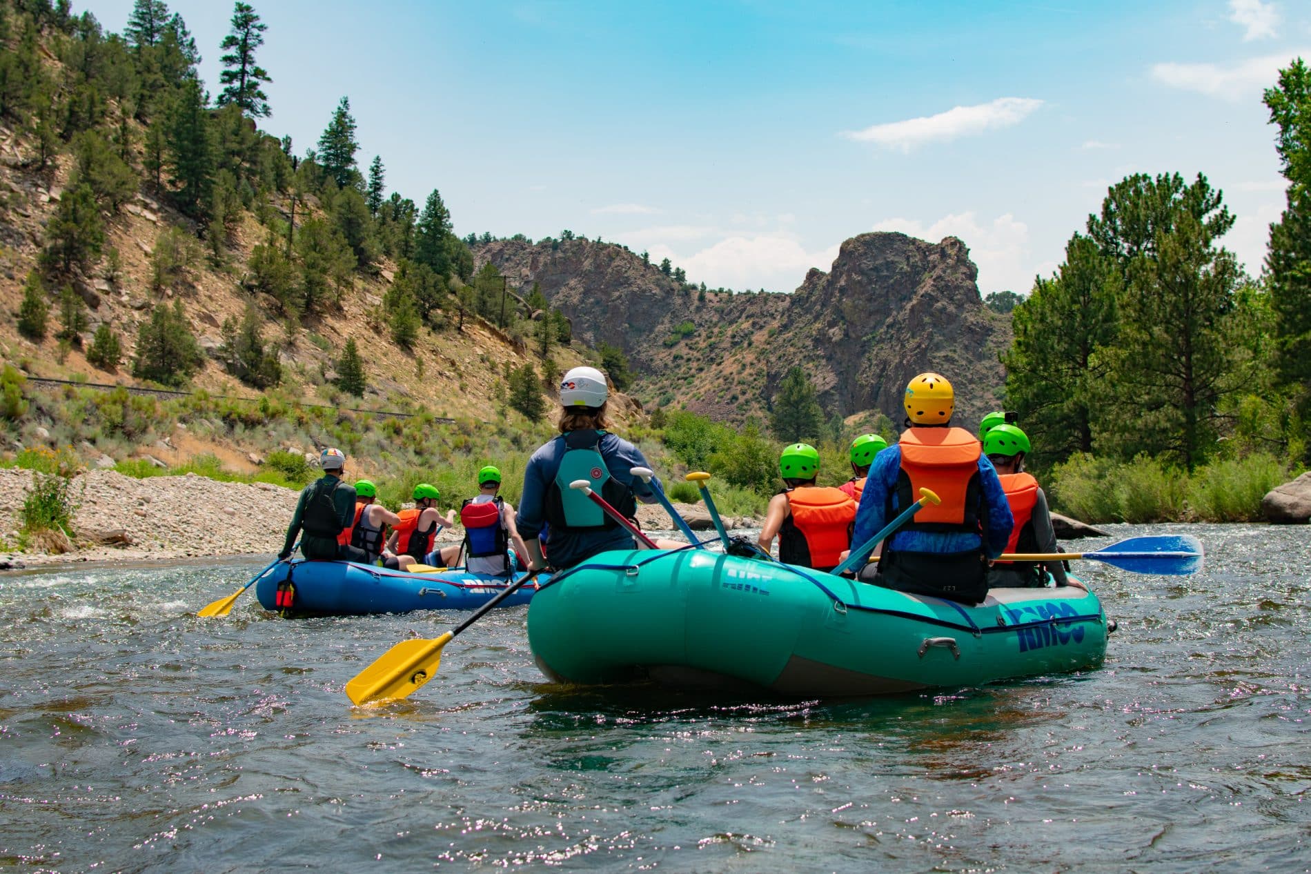 2 rafts from behind with mountains