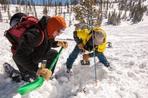 Two people practicing avalanche rescue