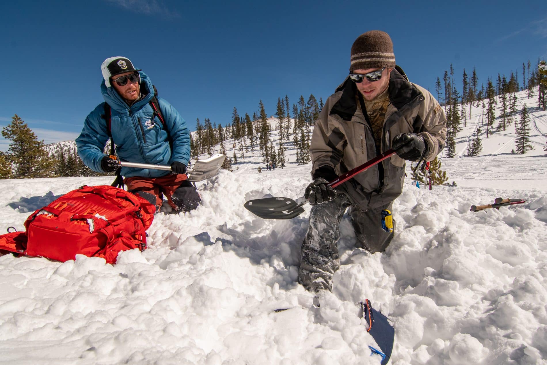 skiers shoveling out snow