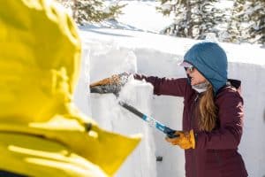 Woman sawing into ice