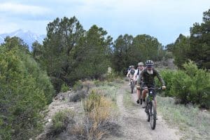 Group of people biking down a trail