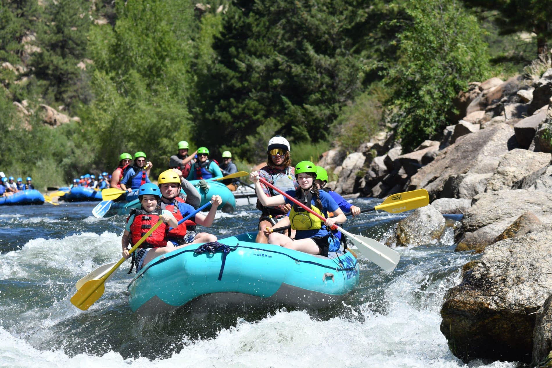 several families rafting in different boats