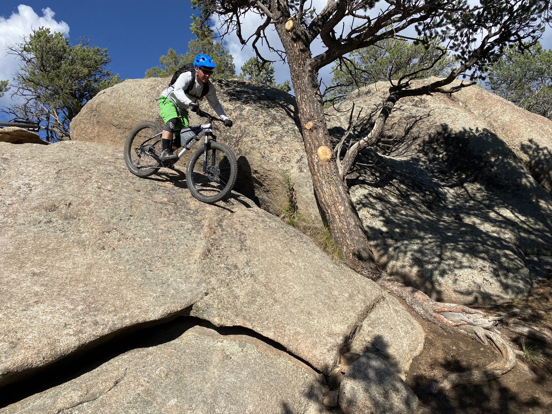 Person biking down a rock