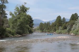 Family float in Salida with bridge in background
