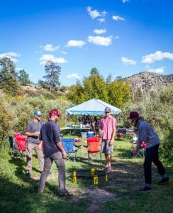 Four men playing spike ball