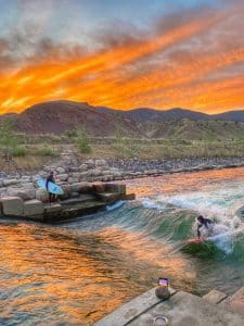 River surfing at sunset