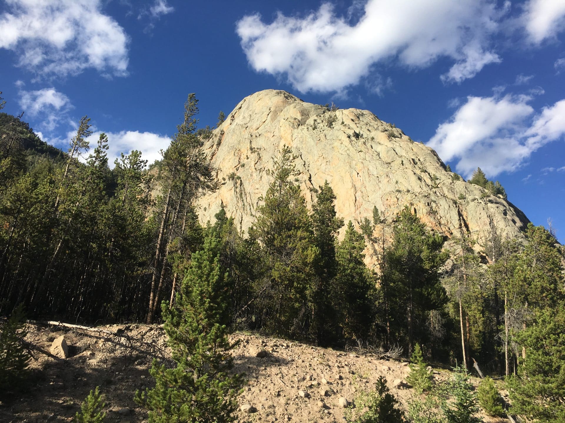 large white rockface under a blue sky