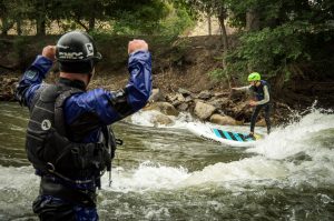 kid learning to river surf