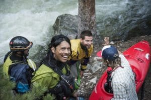 4 kayakers joking around