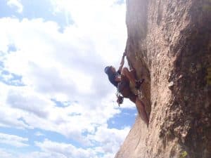 person climbing a rock face